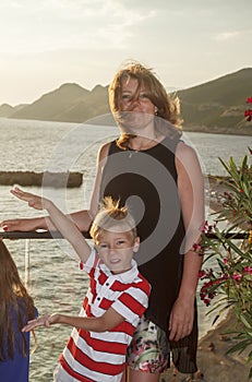 concept of a great holiday with children at sea. cute woman with