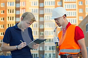 Concept, group of builders in hardhats with clipboard