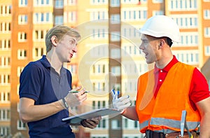 Concept, group of builders in hardhats with clipboard