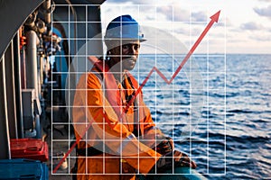 Concept of growth up in marine industry with rising graphics. Seaman AB or Bosun on deck of vessel or ship , wearing PPE