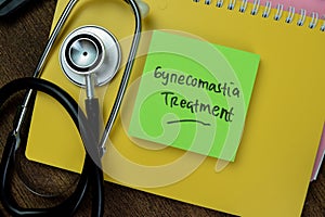 Concept of Gynecomastia Treatment write on sticky notes with stethoscope isolated on Wooden Table