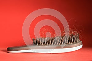 the concept of hair loss in women. comb with hair close-up
