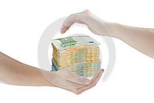 Concept of hands protecting pile of money