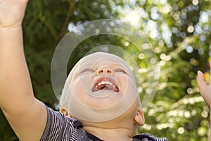 Concept of happiness .Close up portrait of smiling happy baby boy. Bottom view