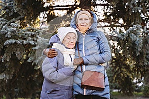 Concept of happy family, old age, emotions, senior care in retirement age. Active senior grandmother and adult daughter hugging