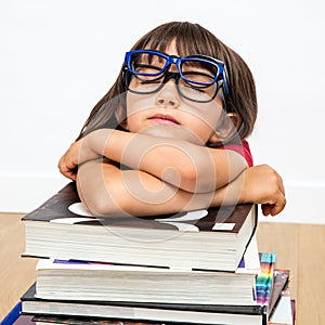 Concept of happy gifted child with eyeglasses sleeping, white background