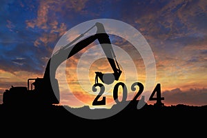 Concept happy new year 2024,crawler excavator silhouette