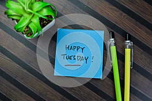 Concept of Happy Tuesday write on sticky notes isolated on Wooden Table