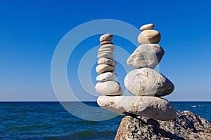 Concept of harmony and balance. Rock Zen on the background of summer sea.