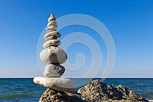 Concept of harmony and balance. Rock Zen on the background of summer sea.