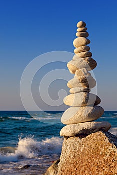 Concept of harmony and balance. Rock Zen at sunset.