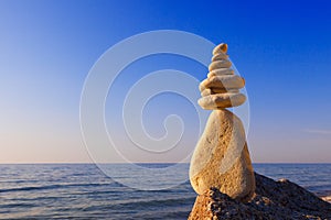 Concept of harmony and balance. Rock Zen at sunset.