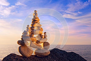 Concept of harmony and balance. Rock Zen at sunset.