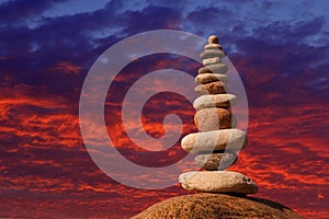 Concept of harmony and balance. Rock Zen on sunset background.