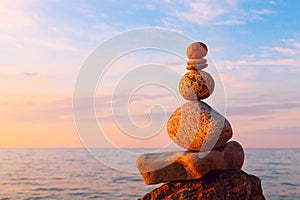 Concept of harmony and balance. Rock Zen at sunset. Balance and
