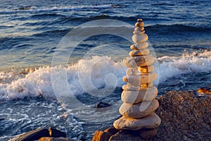 Concept of harmony and balance. Rock Zen at sunset. Balance and poise stones against the sea.