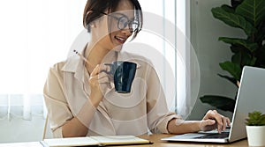 Concept of having a workplace at home. Side profile half-faced photo of happy cheerful smiling excited woman drinking coffee and photo