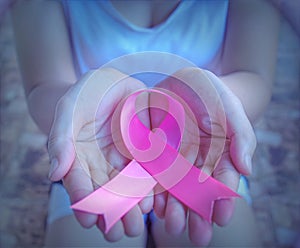 The concept of health care and breast cancer encouraging people around the world of breast cancer patients. Close up holding pink