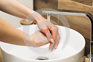 Concept of health, cleaning and preventing germs and coronavirus from contacting hands. Hands of woman wash their hands