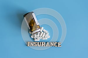 The concept of health insurance. Insurance inscription on the background of tablets