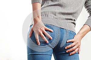 Concept of health problems woman has hemorrhoids
