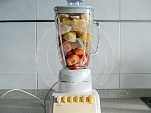 Concept: healthy food. Fruit in a blender to make a smoothie