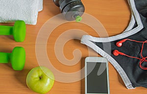 The concept of a healthy lifestyle. Apple, dumbbell, bottle, towel, t-shirt