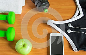 The concept of a healthy lifestyle. Apple, dumbbell, bottle, towel, t-shirt