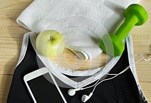 The concept of a healthy lifestyle. Apple, dumbbell, towel, t-shirt