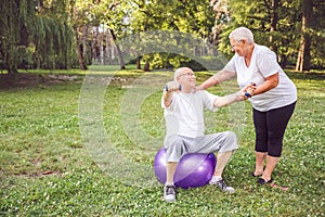 Concept of healthy lifestyle - pensioner man and woman doing tog