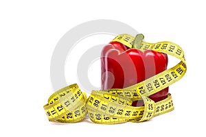 Concept healthy lifestyle, sport, fitness and diets, healthy food, pepper red in measuring tape on white background. isolation