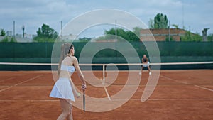 Concept of healthy lifestyle and sport two professional tennis players women have a match outdoor on tennis court they