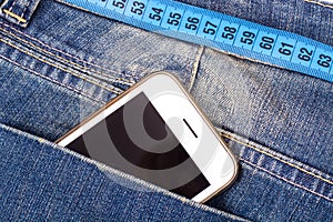 Concept of healthy lifestyle, weight loss. Jeans with measuring tape