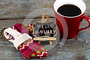 Concept HELLO january message on blackboard with a Cup of coffee