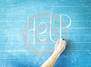 Teacher writes help on blackboard