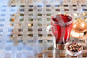 Concept of herbal tea. Hibiscus tea in a glass mug with turkish