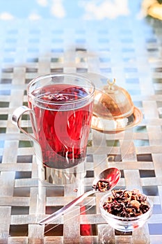 Concept of herbal tea. Hibiscus tea in a glass mug with turkish