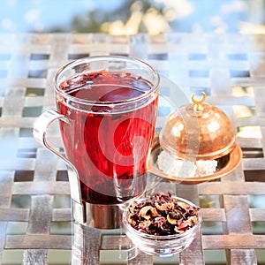 Concept of herbal tea. Hibiscus tea in a glass mug with turkish