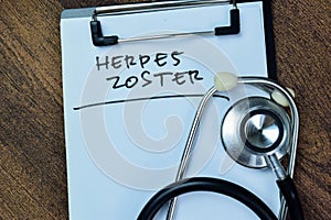 Concept of Herpes Zoster write on paperwork with stethoscope isolated on Wooden Table