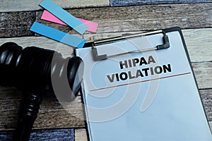 Concept of HIPAA Violation write on paperwork isolated on wooden background