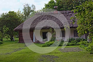 Concept of historical buildings in ancient Ukrainian village. Reconstruction of an ancient clay house with front yard