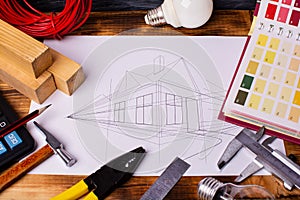 Concept of home improvement. a set of tools and a drawing of the house