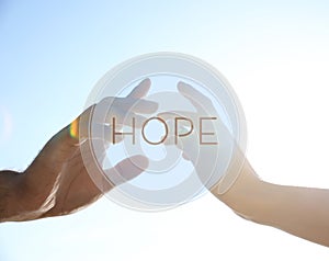 Concept of hope. Man and woman reaching hands to each other, closeup
