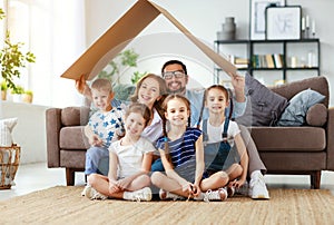 Concept of housing and relocation. happy  big family mother father and kids with roof at home