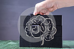 The concept of the human brain. Education, science and medical concept.  Brain drawn in chalk on black cubes