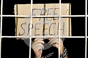 Concept human rights freedom of speech hands shackled with an iron chain hold a cardboard sign with the inscription free speech