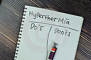 Concept of Hyperthermia write on a book isolated on Wooden Table