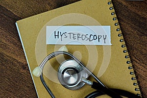 Concept of Hysteroscopy write on sticky notes with stethoscope isolated on Wooden Table