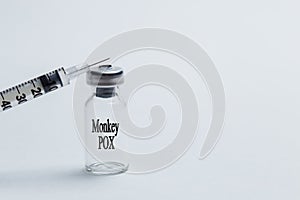The concept of the IgG, IgM monkeypox virus (MPXV) test. Ampoule with a syringe on a white background photo