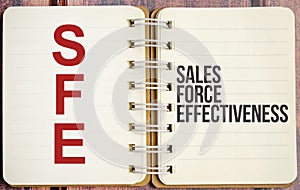 Concept image of Accounting Business Acronym SFE Sales Force Effectiveness written on white notebook